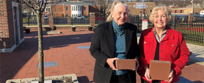 People holding Reilly bricks